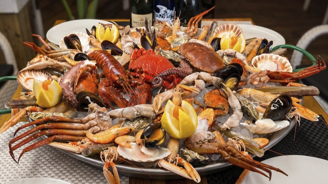 Puerto Rico seafood platter with lobster, langoustines, mussels and scallops on Magaluf beach